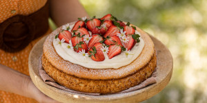 Beitragsbild des Blogbeitrags WIR FEIERN BALD MUTTERTAG! Süße Reistorte mit Holunder-Topfencreme und glücklichen Erdbeeren 