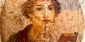 Beitragsbild des Blogbeitrags Viviana, die das Leben in Pompeji liebt, den Griffel auf den Lippen, unterbricht sie ihre Notizen und sieht versonnen zu mir ...  